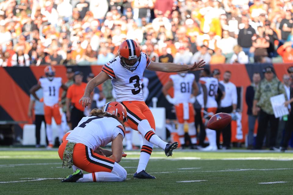 Cleveland Browns kicker Chase McLaughlin (3) kicks a field goal out of the hold of Jamie Gillan (7) during the second half of an NFL football game against the Cincinnati Bengals, Sunday, Nov. 7, 2021, in Cincinnati. (AP Photo/Aaron Doster)