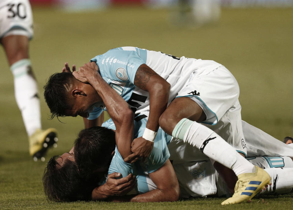 Racing Club's midfielder Augusto Solari celebrates with his teammates after scoring against Tigre during an Argentine Superliga soccer match in Victoria, on the outskirts of Buenos Aires, Argentina, Sunday, March 31, 2019. (AP Photo/Mariano Blanc)