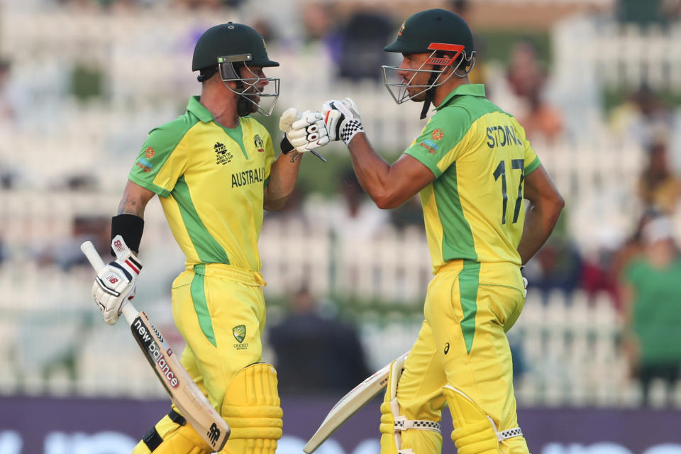 Australia's Marcus Stoinis, right, gestures to teammate Matthew Wade during the Cricket Twenty20 World Cup match between South Africa and Australia in Abu Dhabi, UAE, Saturday, Oct. 23, 2021. (AP Photo/Kamran Jebreili)