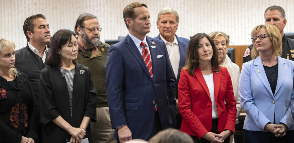 A group of officials including member of the Orange County Board of Supervisors Michele Park Steele, from third left, Rep. Harley Rouda, Assemblywoman Cottie Petrie-Norris and Costa Mesa Mayor Katrina Foley, hold a news conference in Costa Mesa, Calif., Saturday, Feb. 22, 2020. A court temporarily blocked the U.S. government from sending up to 50 people infected with a new virus from China to the Southern California city for quarantine after local officials argued that the plan lacked details about how the community would be protected from the outbreak. (Mindy Schauer/The Orange County Register via AP)