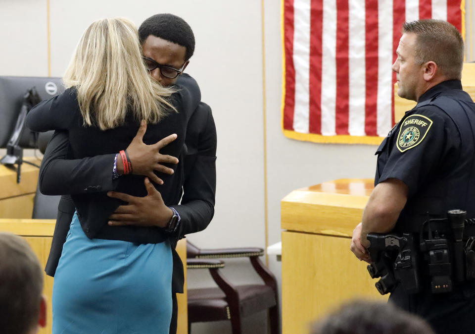 Botham Jean's younger brother Brandt Jean hugs convicted murderer and former Dallas Police Officer Amber Guyger after delivering his impact statement to her after she was sentenced to 10 years in jail, Wednesday, Oct. 2, 2019, in Dallas. Guyger shot and killed Botham Jean, an unarmed 26-year-old neighbor in his own apartment last year. She told police she thought his apartment was her own and that he was an intruder. (Tom Fox/The Dallas Morning News via AP, Pool)