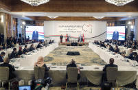 Tunisian President Kais Saied, left, and Stephanie Williams, Acting Special Representative of the Secretary-General and Head of the United Nations Support Mission attend the opening ceremony of the Libya's peace talks in Tunis, Tunisia, Monday Nov. 9, 2020. Libya's rival factions began much-awaited political peace talks in Tunisia's capital on Monday brokered by the United Nations, with a goal of drawing a roadmap to presidential and parliamentary elections. (AP Photo/Hassene Dridi)