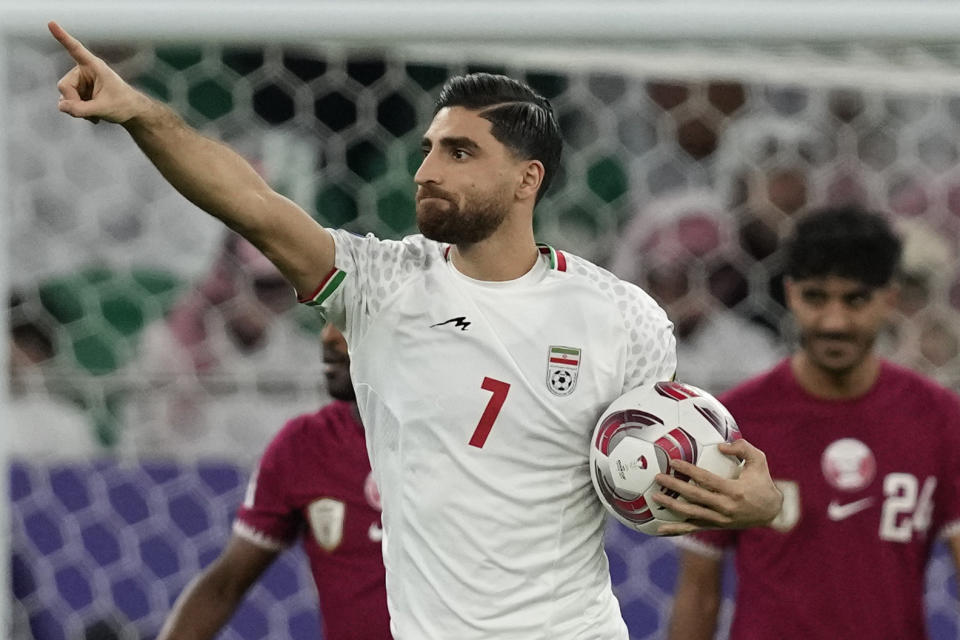 Iran's Alireza Jahan Bakhsh celebrates after scoring in a penalty kick during the Asian Cup semifinal soccer match between Qatar and Iran at Al Thumama Stadium in Doha, Qatar, Wednesday, Feb. 7, 2024. (AP Photo/Thanassis Stavrakis)