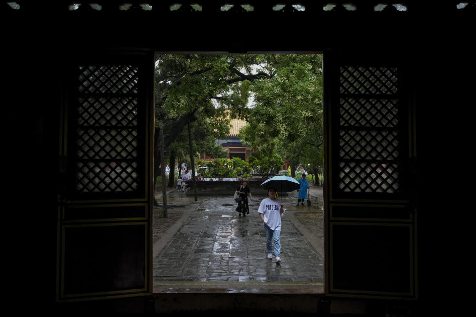 Visitors tour the Garden of the Palace of Compassion and Tranquility, known as Dining gong huayuan, at the Forbidden City in Beijing on Thursday, July 13, 2023. The mortar that holds together some of China’s most famous structures — including the Great Wall and the Forbidden City — includes traces of starch from sticky rice. (AP Photo/Andy Wong)