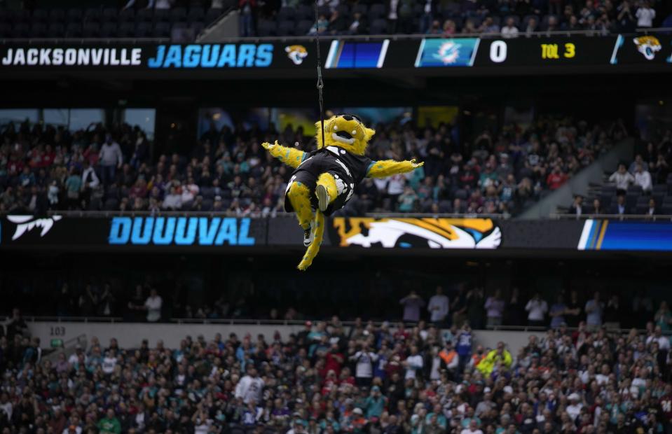 Jacksonville Jaguars mascot Jaxson de Ville gestures after bungee jumping off the stadium roof before an NFL football game between the Miami Dolphins and the Jacksonville Jaguars at the Tottenham Hotspur stadium in London, England, on Sunday, Oct. 17, 2021.