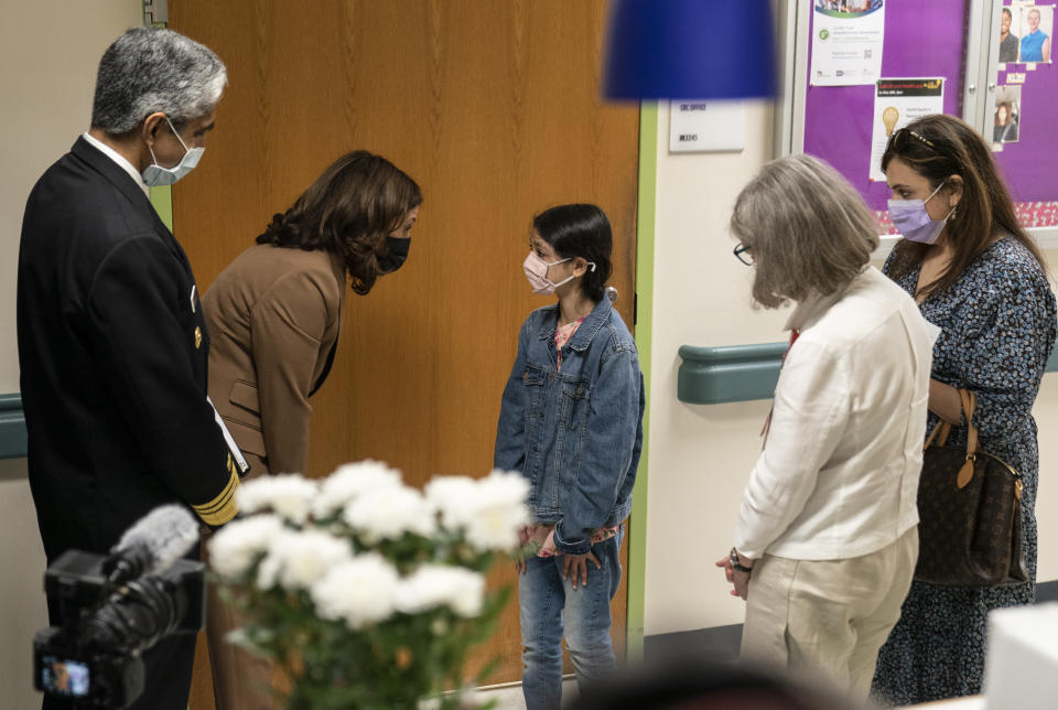 Vice President Kamala Harris, joined by Surgeon General Vivek Murthy, right, greets a your patient during a tour at Children's National Hospital, Monday, May 23, 2022. (AP Photo/ Carolyn Kaster)