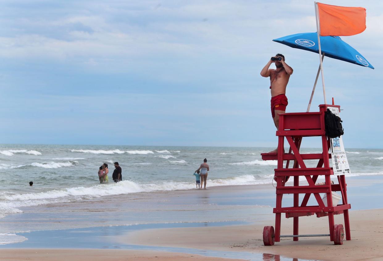 A lifeguard keeps an eye on swimmers near Andy Romano Park in Ormond Beach. The remnants of the hurricane out in the Atlantic will combine with other storms to create a risk of danergous rip currents this weekend in Volusia and Flagler counties.