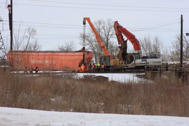 Crews work to move a train car that derailed in Calgary on Sunday.