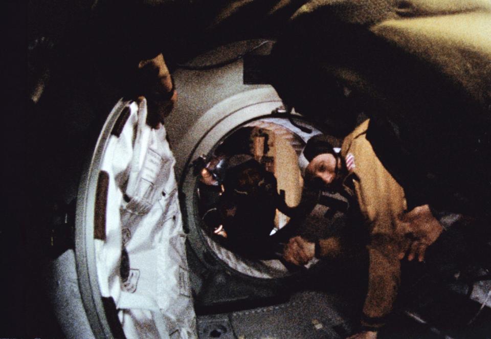 Thomas Stafford, right, shaking hands with Alexei Leonov in the docking tunnel between Apollo and Soyuz on July 17 1975