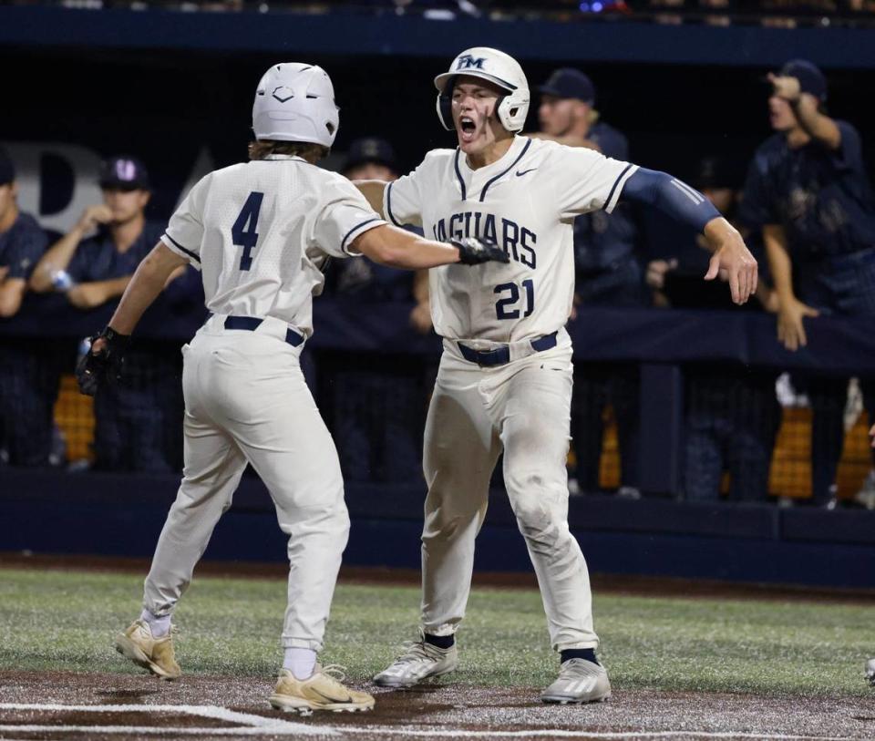 Flower Mound center fielder Sam Erickson (21) celebrates with outfielder Kyle Conne (4) after they scored in the bottom of the sixth during the Conference 6A Region 1 Semi-final baseball playoffs at Dallas Baptist University in Dallas, Texas, Friday May 24, 2024.