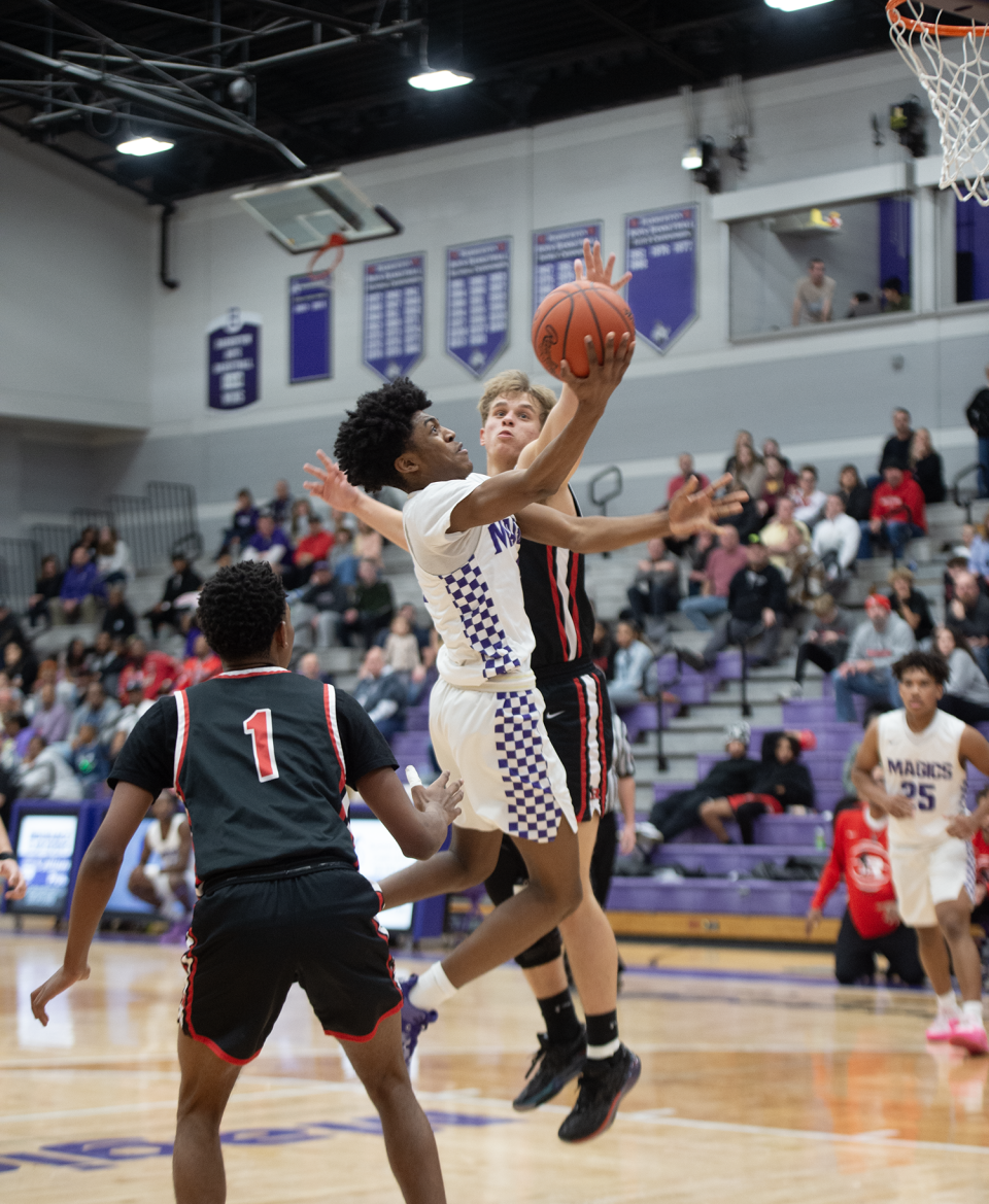 Barberton's Kameryn Kennerly takes a shot as Kent Roosevelt's Carter Foreman defends on Feb. 9, 2024.