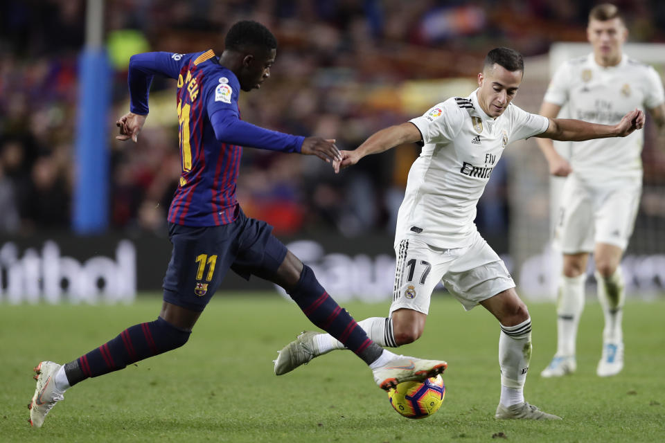 Barcelona forward Ousmane Dembele, left, and Real forward Lucas Vazquez compete for the ball during the Spanish La Liga soccer match between FC Barcelona and Real Madrid at the Camp Nou stadium in Barcelona, Spain, Sunday, Oct. 28, 2018. (AP Photo/Manu Fernandez)