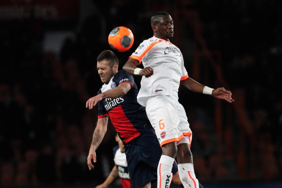 Paris Saint Germain's Jeremy Menez, left, challenges for the ball with Valencienne's Hamed Doumbia, during their French League one soccer match, at the Parc des Princes stadium, in Paris, Friday, Feb. 14, 2014. (AP Photo/Thibault Camus)