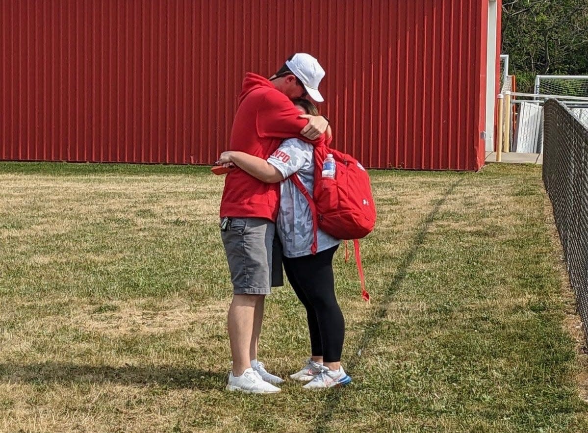 Fairport coach Mara Karpp right and Penfield coach Dave York embrace after Fairport won the 2023 NYSPHSAA Class A championship.