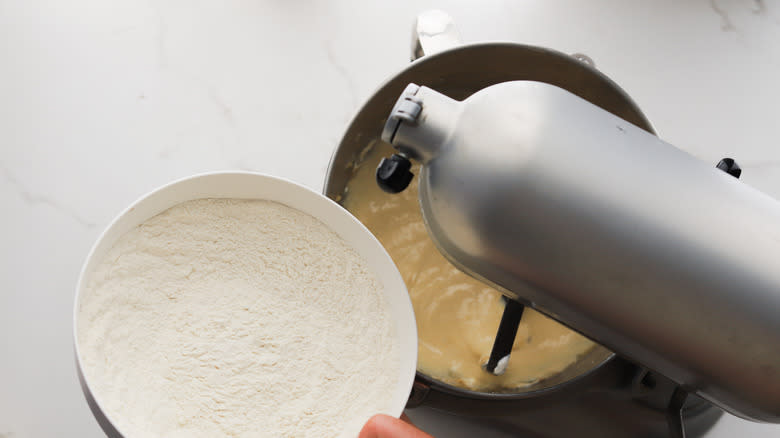 Adding dry ingredients to bowl