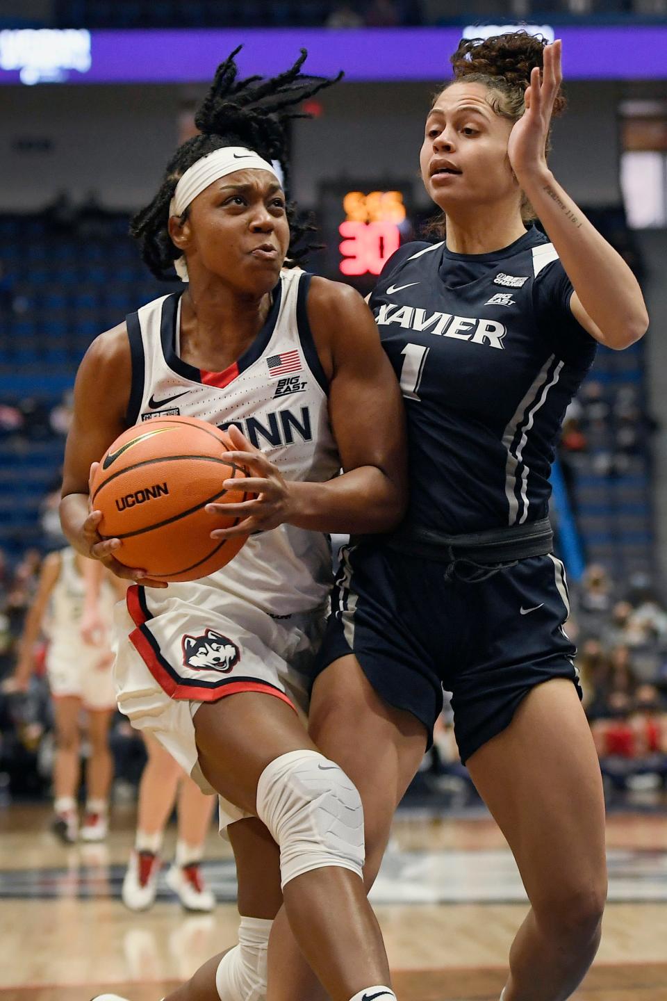 UConn's Christyn Williams (13) is guarded by Xavier's Nia Clark (1) during the Huskies' win Saturday in Hartford.