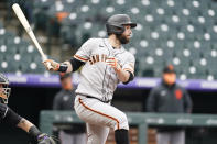 San Francisco Giants' Brandon Belt follows the flight of his single off Colorado Rockies relief pitcher Jhoulys Chacin in the fourth inning of game one of a baseball doubleheader Tuesday, May 4, 2021, in Denver. (AP Photo/David Zalubowski)