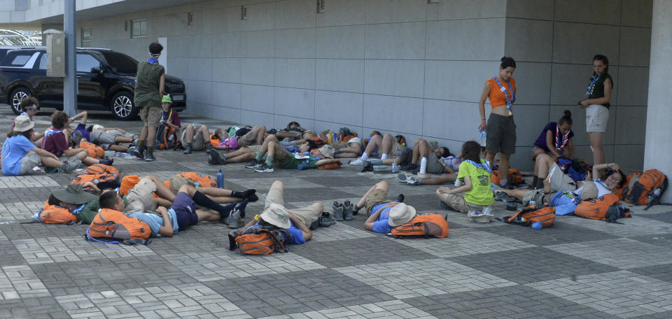 Attendees of the World Scout Jamboree lie down to rest at a scout camping site in Buan, South Korea, Friday, Aug. 4, 2023. More than 4,000 British Scouts will leave the World Scout Jamboree at a campsite in South Korea and move into hotels this weekend, the U.K. Scout Association said Friday, as concerns grow after more than 100 participants were treated for heat-related ailments. (Kim-yeol/Newsis via AP)