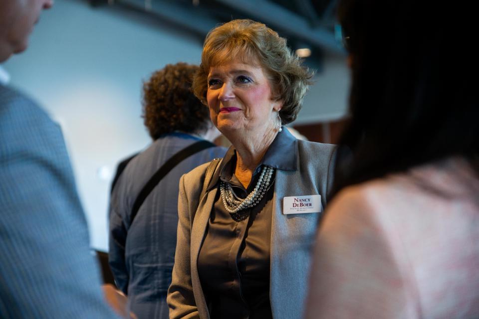 Former Holland Mayor Nancy DeBoer talks with her fellow candidates and voters after a West Coast Chamber of Commerce forum on Monday, June 20, 2022, at Boatwerks in Holland.