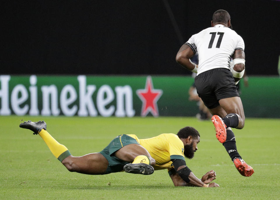 Fiji's Semi Radradra runs past Australia's Marika Koroibete during the Rugby World Cup Pool D game at Sapporo Dome between Australia and Fiji in Sapporo, Japan, Saturday, Sept. 21, 2019. (AP Photo/Aaron Favila)