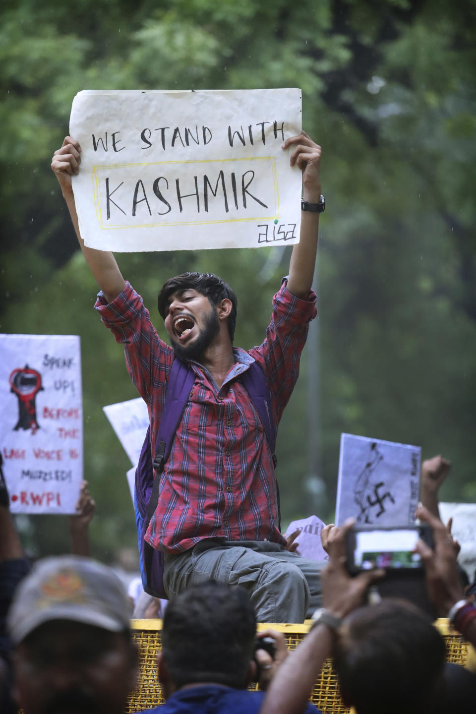 FILE - In this Aug. 5, 2019, file photo, left party supporters and students shout slogans during a protest against the Indian government revoking Kashmir's special constitutional status in New Delhi, India. India on Thursday, Oct. 31, 2019, formally implemented legislation approved by its Parliament in early August that removes Indian-controlled Kashmir's semi-autonomous status and begins direct federal rule of the disputed area amid a harsh security lockdown and widespread public disenchantment. (AP Photo/Manish Swarup, File)