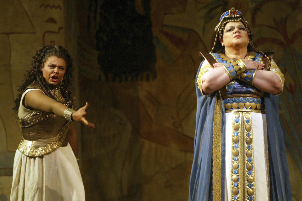 FILE - Fiorenza Cedolins, left, performs the title roll in Guiseppe Verdi's "Aida" alongside Dolora Zajick performing as Amneris during dress rehearsal at the Metropolitan Opera, on Oct. 13, 2004, in New York. Sonja Frisell's staging of Verdi's `Aida' ends its 35-year-run at Metropolitan Opera on Thursday. A new version by Tony Award winner Michael Mayer is to open in 2024-25. (AP Photo/Mary Altaffer, File)