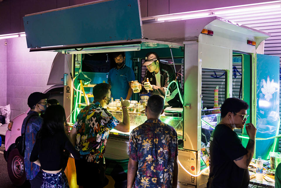 A vendor on Khao San Road in Bangkok shows customers his different cannabis offerings.<span class="copyright">Cedric Arnold for TIME</span>