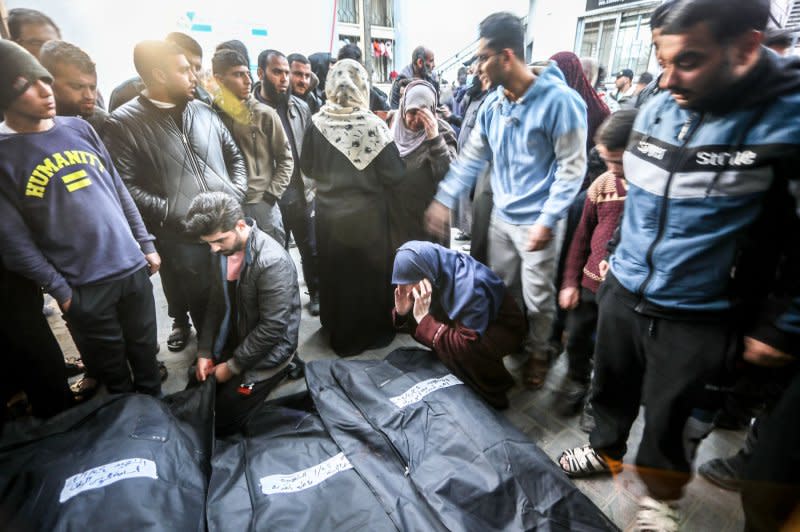 Relatives of the Palestinians killed in Israeli attacks mourn over dead bodies following an Israeli strike in Rafah in the southern Gaza Strip that reportedly inflicted "mass casualties" on Wednesday. The air strikes were part of an IDF effort to "eliminate terrorists" operating in southern Gaza. Photo by Ismael Mohamad/UPI