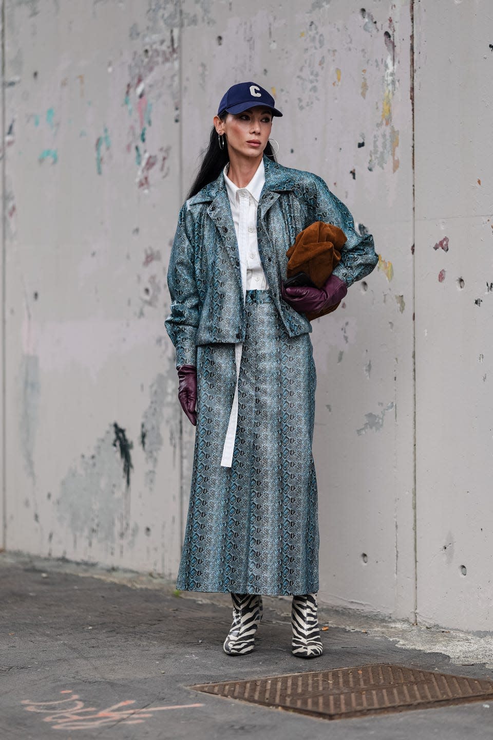 woman in blue leather outfit at milan fashion week