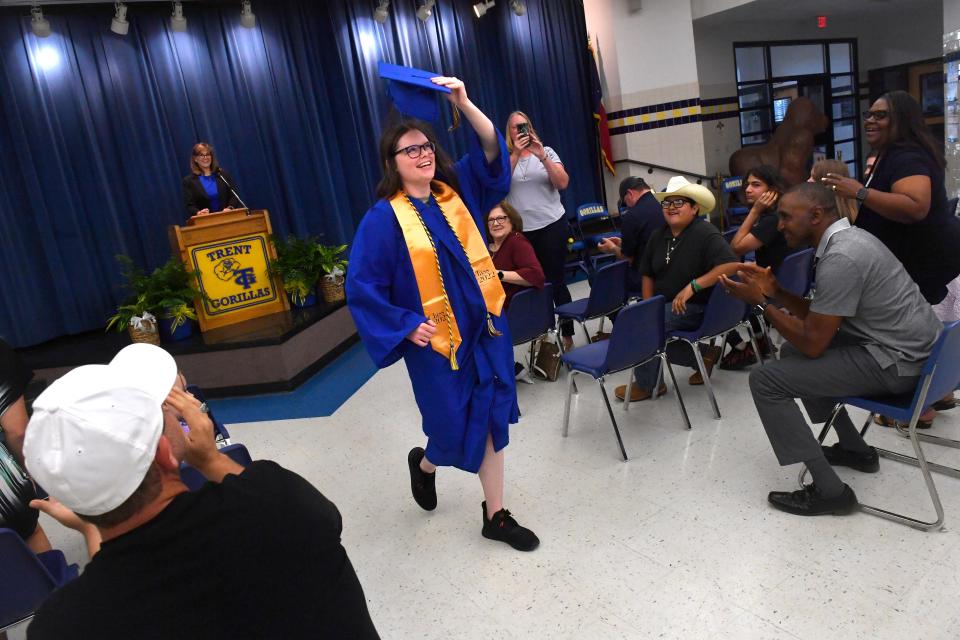 Elise Weaver tosses her cap into the air as she graduates from Trent High School on May 26, 2022. Weaver was the only member of her graduating class.