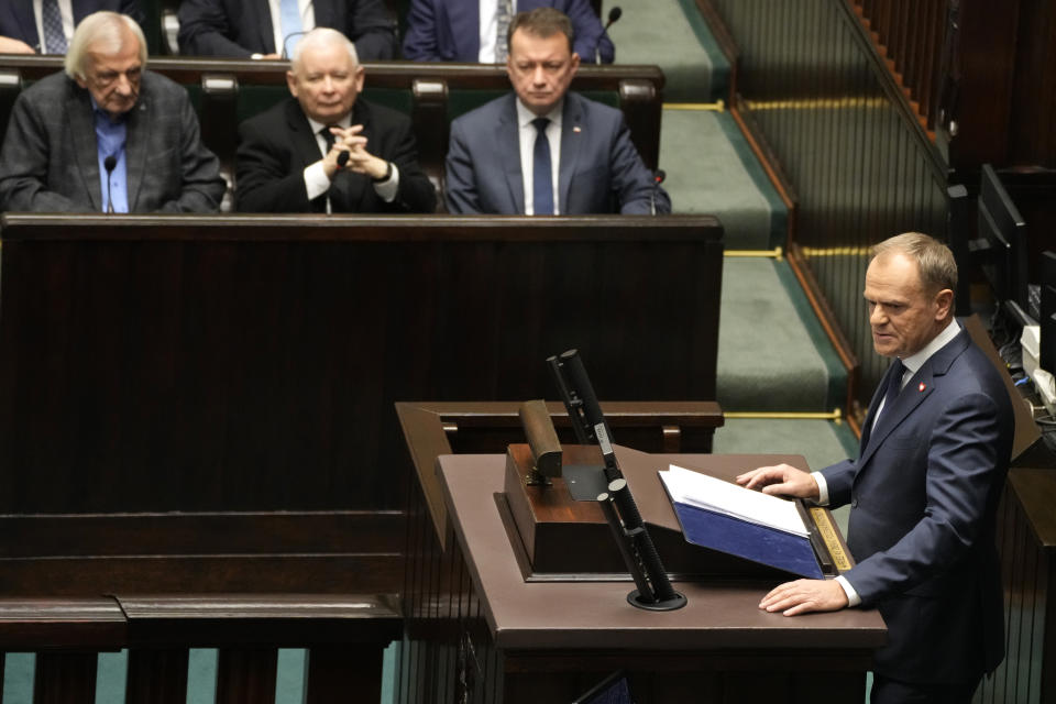 Newly elected Poland's Prime Minister Donald Tusk speaks to lawmakers at the parliament in Warsaw, Poland, Tuesday Dec. 12, 2023. (AP Photo/Czarek Sokolowski)