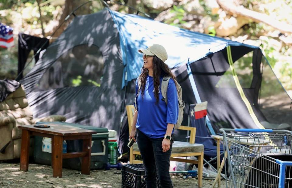 Diana Salazar, a team lead of the DRC outreach team, smiles while talking to clients on Friday, June 30, 2023. The Fort Worth nonprofit works primarily towards getting their clients, who are unsheltered and often located in campsites hidden in wooded areas, into permanent housing.