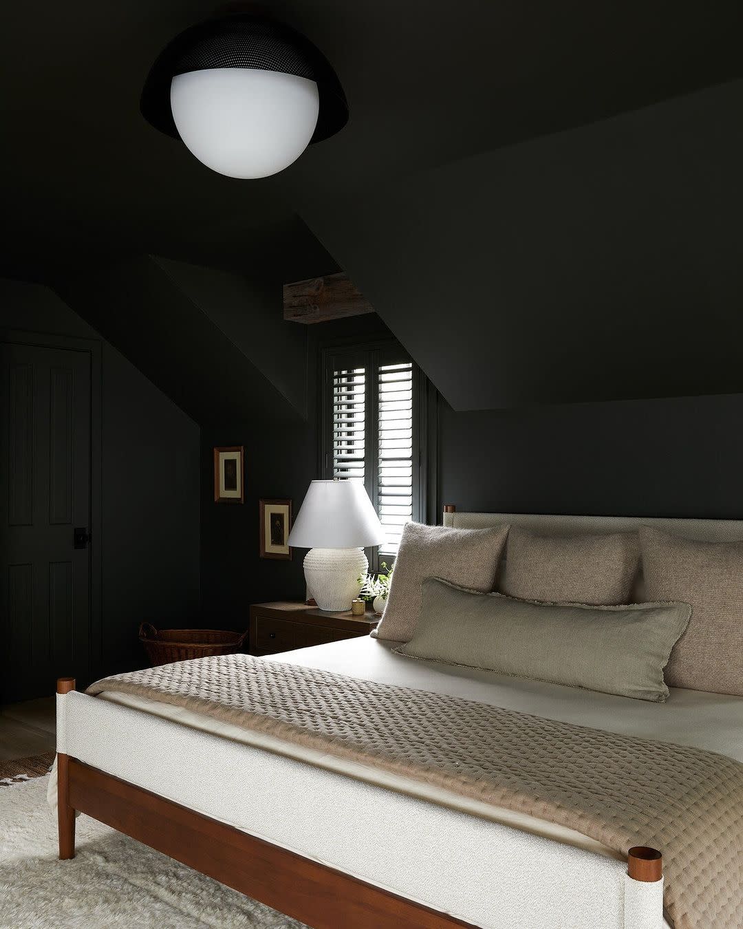  Dark black bedroom with white bed. 