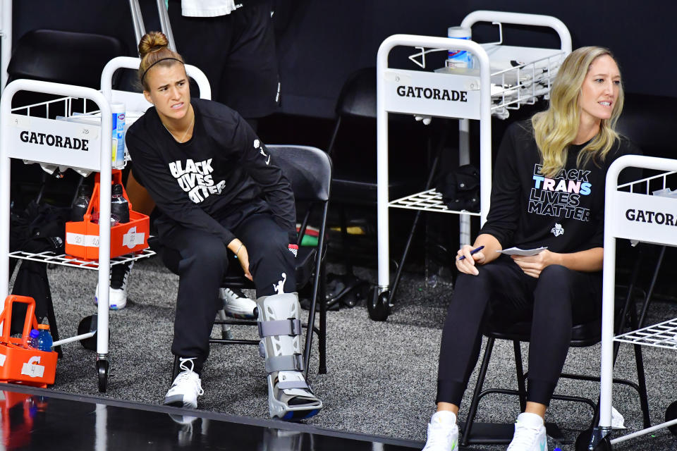 Sabrina Ionescu in a black 'Black Lives Matter" T-shirt and in an ankle boot. 