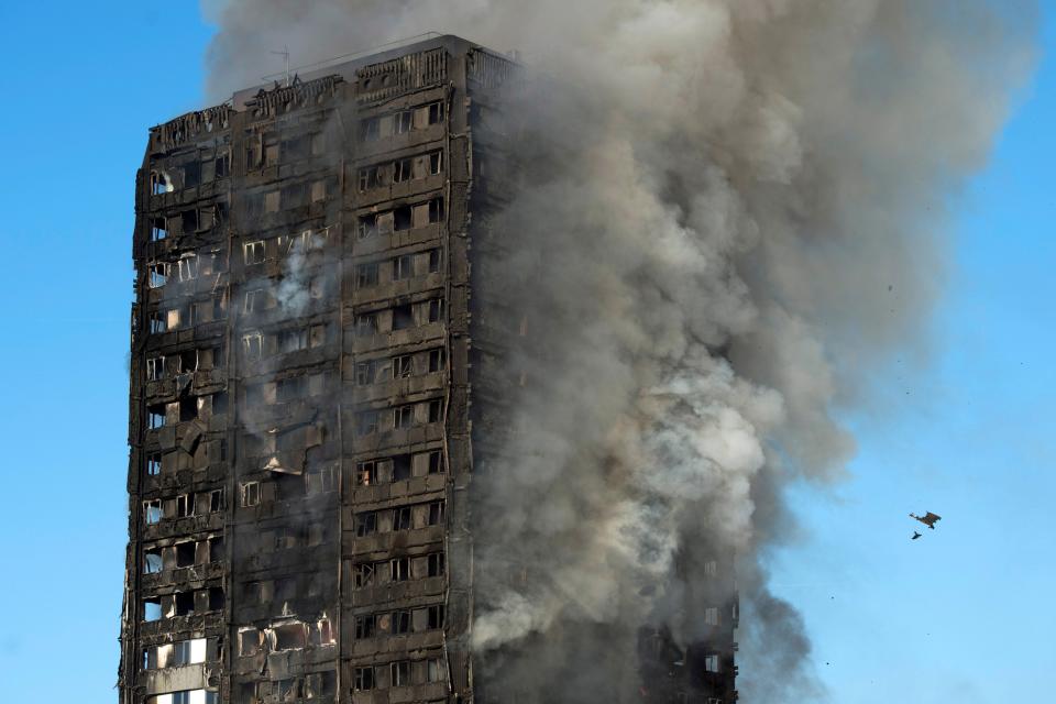 Grey smoke rises from the fire at the Grenfell Tower apartment block in North Kensington (EPA)