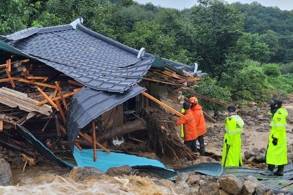 <p>HANDOUT/Gyeongbuk Fire Service Headquarters/AFP via Getty </p> South Korean emergency workers look for survivors amid ongoing floods