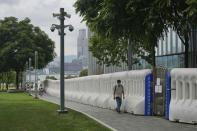 A man wearing face mask to prevent the spread of coronavirus walks outside government headquarters in Hong Kong, Thursday, May 13, 2021. (I AP Photo/Vincent Yu)