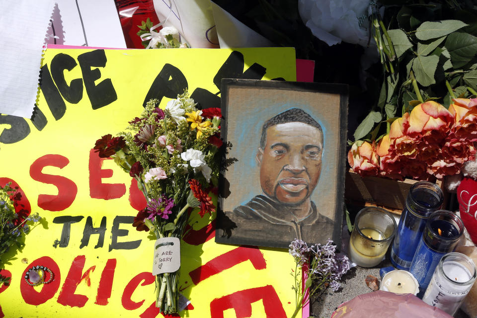 A chain portrait of George Floyd is part of the memorial for him, Wednesday, May 27, 2020, near the site of the arrest of Floyd who died in police custody Monday night in Minneapolis after video shared online by a bystander showed a white officer kneeling on his neck during his arrest as he pleaded that he couldn't breathe. (AP Photo/Jim Mone)