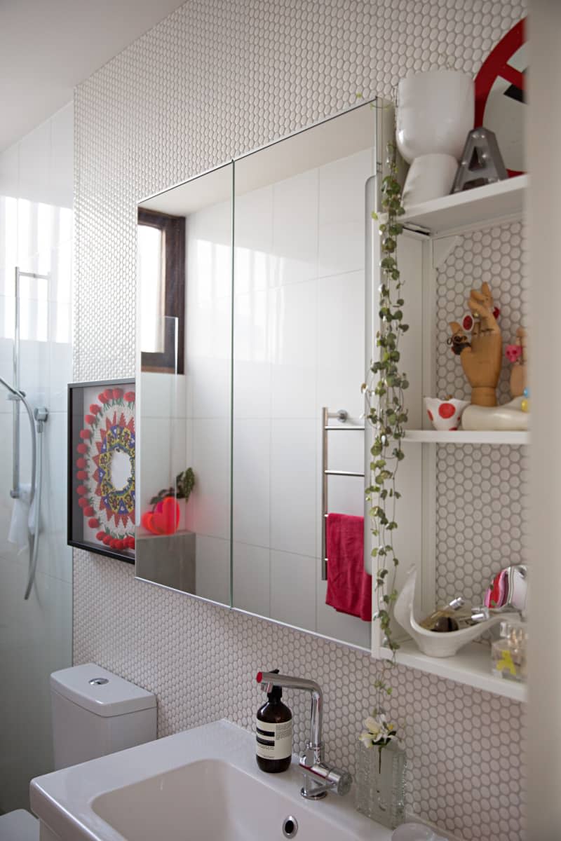 white penny tile on wall with built in mirror medicine cabinet