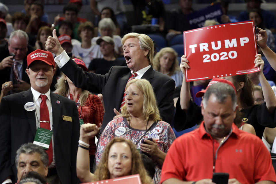 A Donald Trump impersonator cheers before President Donald Trump arrives to speak at his re-election kickoff rally at the Amway Center, Tuesday, June 18, 2019, in Orlando, Fla. (AP Photo/Evan Vucci)