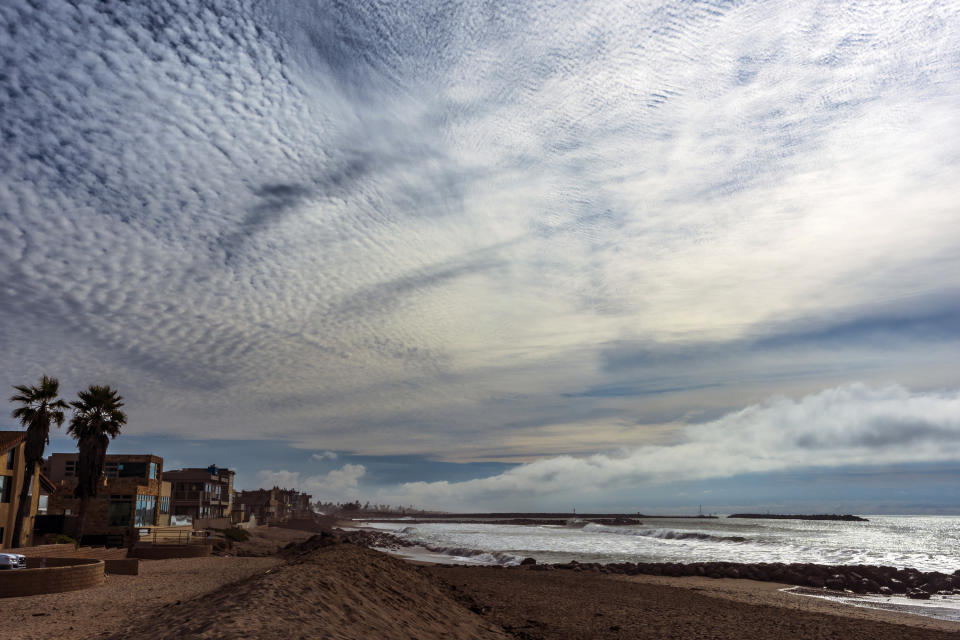 Cloud formations are seen above the beach ahead of storms in Ventura, Calif., Wednesday, Jan. 31, 2024. The first of two back-to-back atmospheric rivers slowly pushed into California on Wednesday, triggering statewide storm preparations and calls for people to prepare for potential flooding, heavy snow, and damaging winds. (AP Photo/Damian Dovarganes)