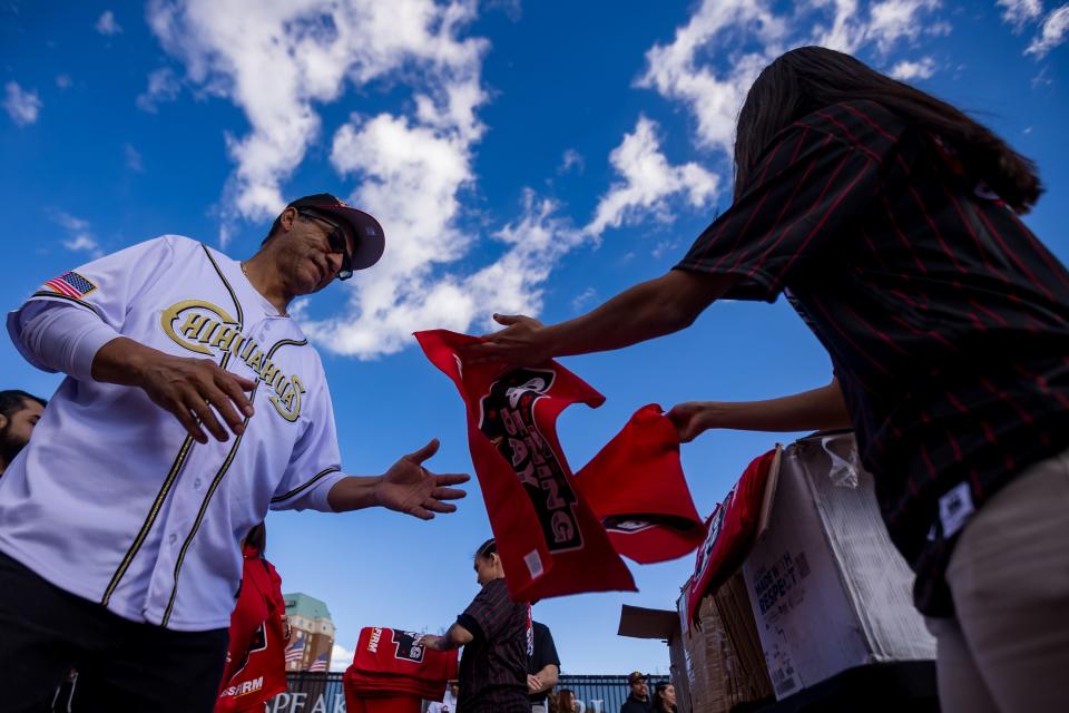 El Paso Chihuahuas fans receive a towel as they enter the Southwest University Park in El Paso, Texas, for the opening day against Round Rock on Tuesday, April 2, 2024.