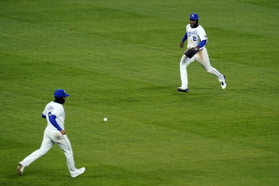 Kansas City Royals shortstop Nicky Lopez, left, center fielder Michael A. Taylor, right, chase a two-run single by Tampa Bay Rays' Yoshi Tsutsugo during the sixth inning of a baseball game Tuesday, April 20, 2021, in Kansas City, Mo. (AP Photo/Charlie Riedel)