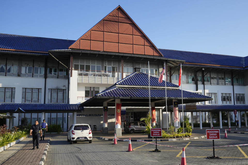 A police officer walks outside the Sultanah Maliha Hospital, where Norway's King Harald believed has been admitted with an infection, on the Malaysian resort island of Langkawi, Malaysia, Thursday, Feb. 29, 2024. Malaysian national news agency Bernama cited unidentified sources as confirming that Europe's oldest monarch was warded at the hospital's Royal Suite. (AP Photo/Vincent Thian)