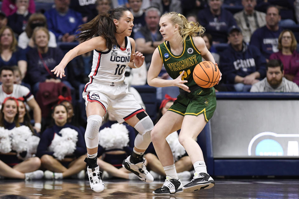 Vermont's Maria Myklebust (21) is guarded by UConn's Nika Muhl (10) in the first half of a first-round college basketball game in the NCAA Tournament, Saturday, March 18, 2023, in Storrs, Conn. (AP Photo/Jessica Hill)