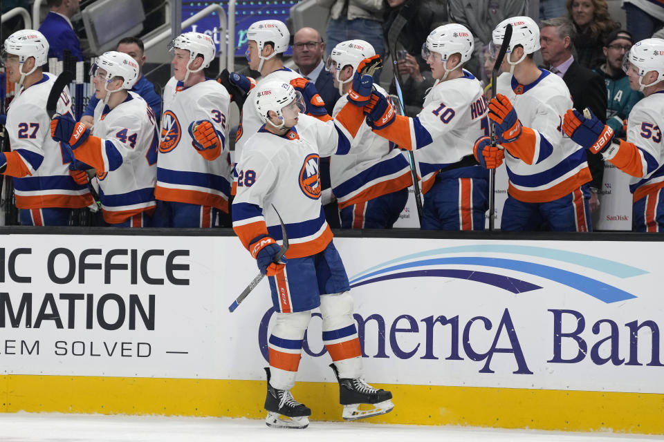 New York Islanders defenseman Alexander Romanov (28) is congratulated for his goal against the San Jose Sharks during the first period of an NHL hockey game Thursday, March 7, 2024, in San Jose, Calif. (AP Photo/Jeff Chiu)