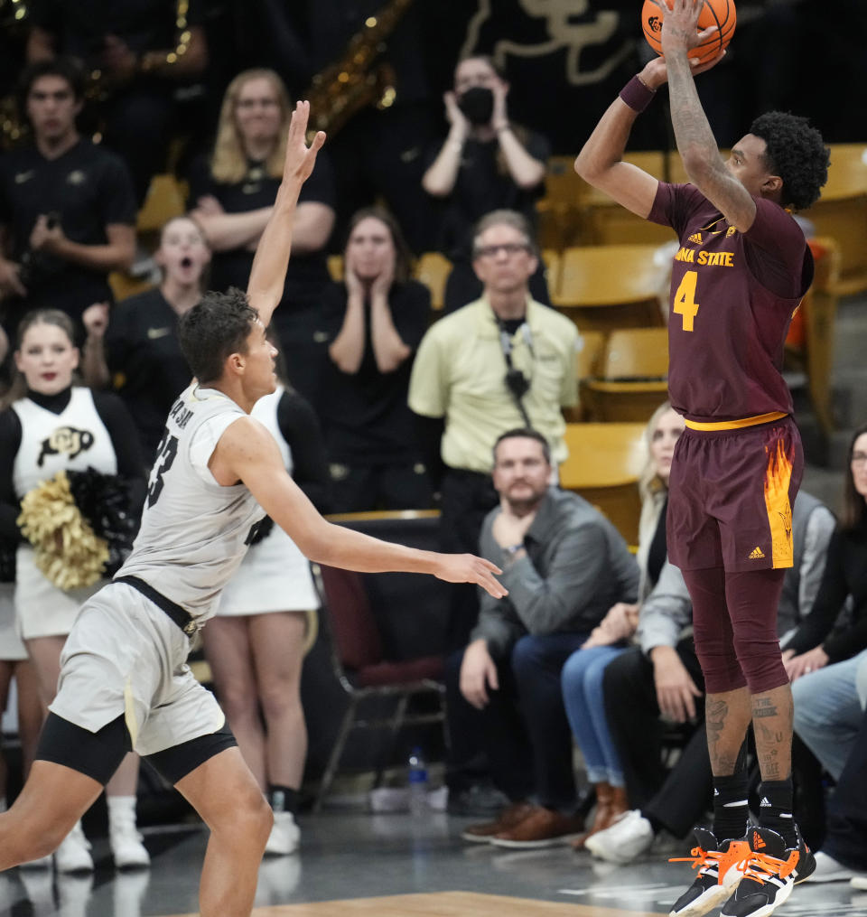 Arizona State guard Desmond Cambridge Jr., right, shoots a 3-point basket with seconds remaining in an NCAA college basketball game against Colorado, Thursday, Dec. 1, 2022, in Boulder, Colo. Colorado forward Tristan da Silva, left, tries to defend on the play. (AP Photo/David Zalubowski)