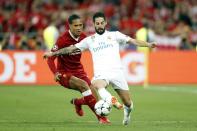 <p>Virgil van Dijk challenges Real Madrid’s Isco </p>