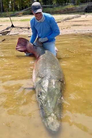 <p>Kirk Kirkland/Facebook</p> The fisherman poses with the alligator gar.
