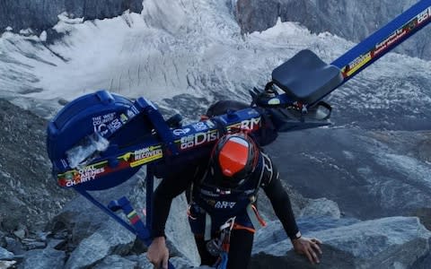 Matthew Paul Disney attempting to scale Mont Blanc with a rowing machine on his back - Credit: Telegraph